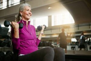 Old woman doing exercise in the gym