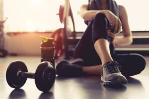 A woman sitting on the gym