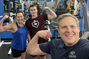 Three people sowing arms and looking ahead